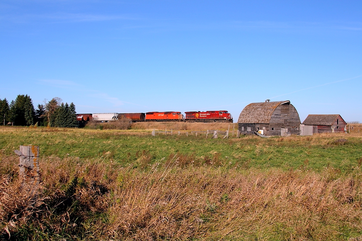 CP 8502 leads a red barn past the old farm at Esmond.