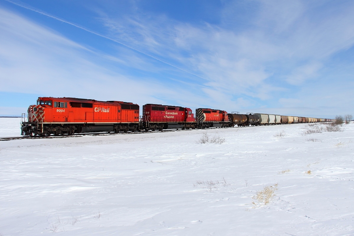 A red barn leads an all EMD lash-up towards Meadows.