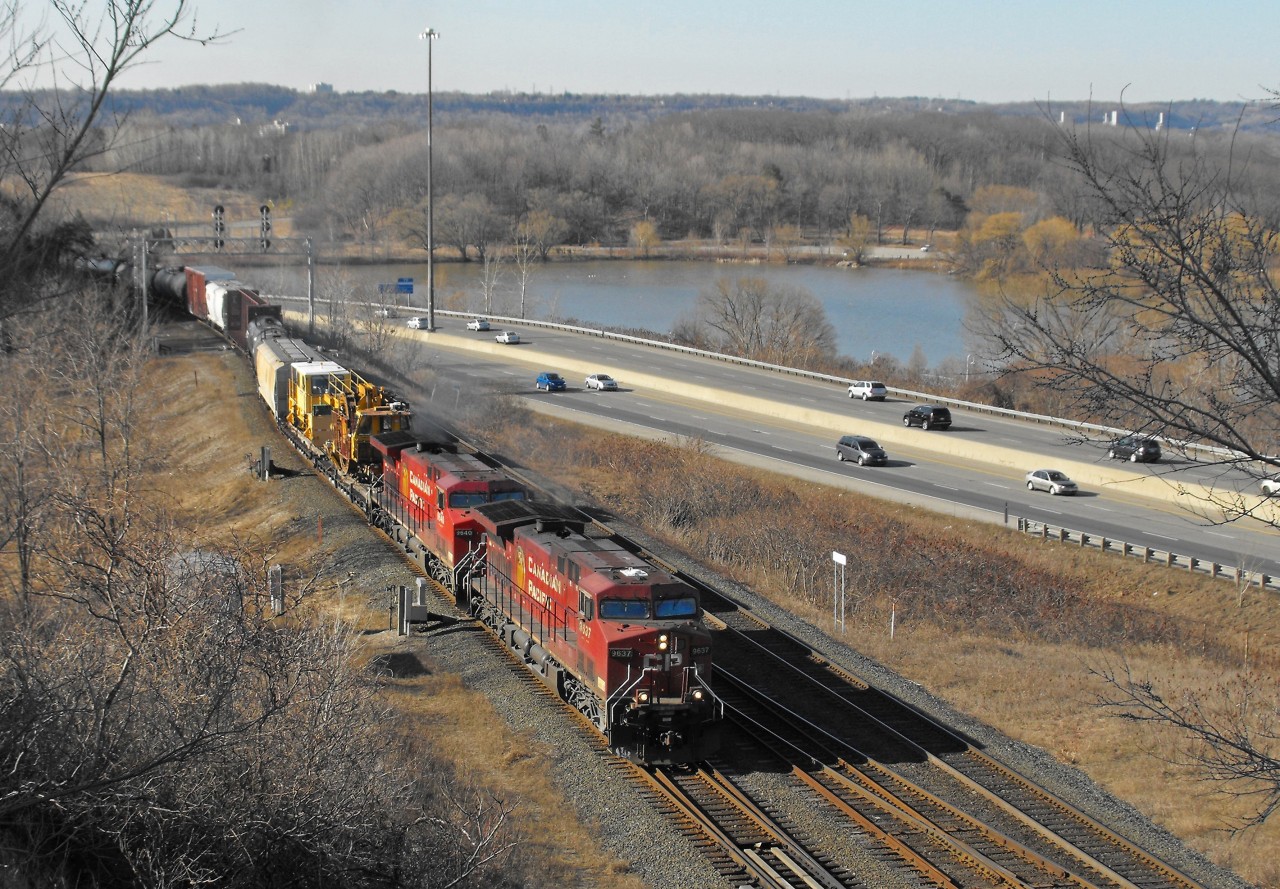 CP 9637 and 9640 have taken the light at Desjardins and will now simultaneously pass over the canal and under the York Blvd. bridge.