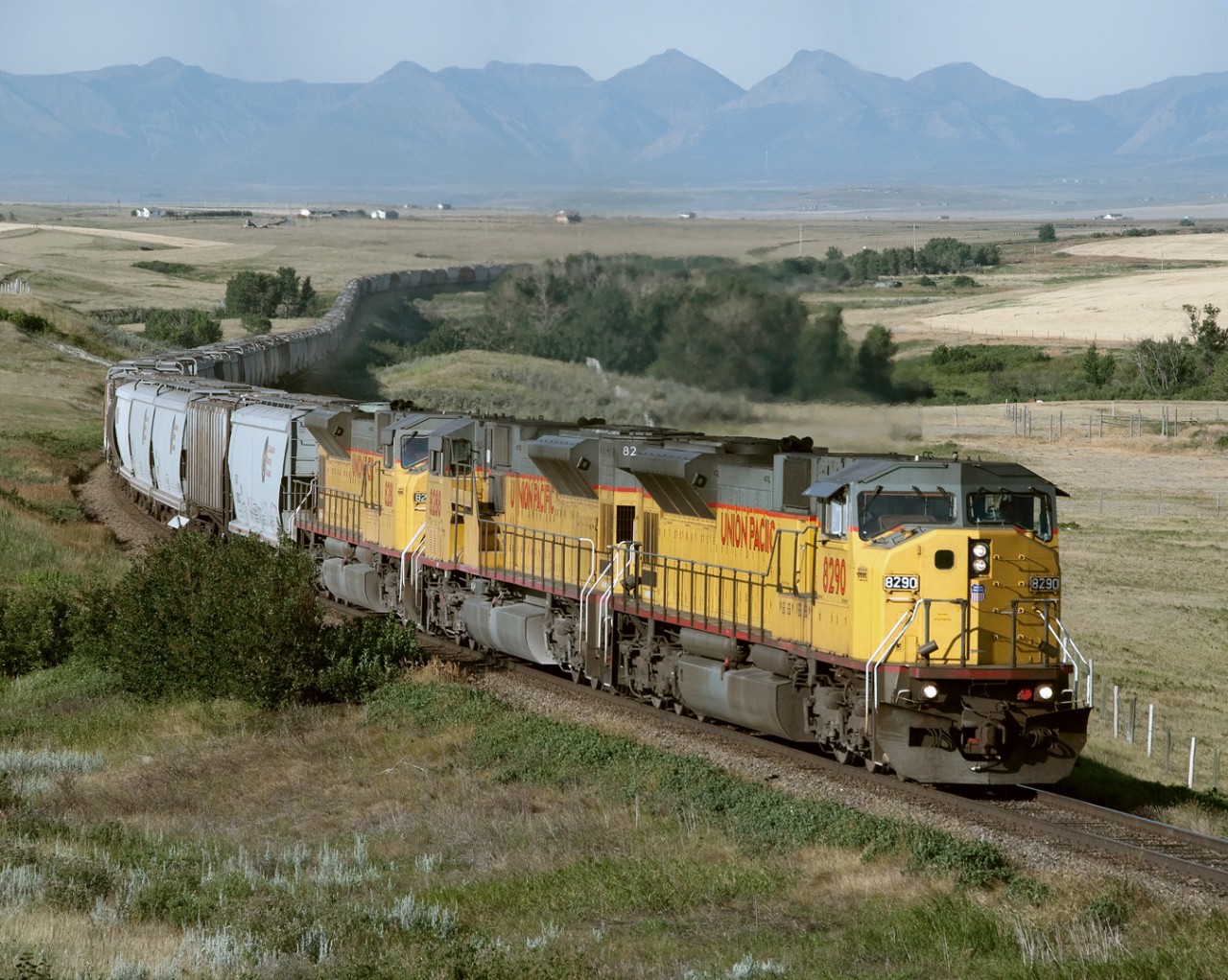Eastbound grain empties with UP run through power from Portland Oregon to Enderlin ND Via Kingsgate and North Portal comes off the Crowsnest Pass and crosses the Peigan Reservation west of Fort Macleod