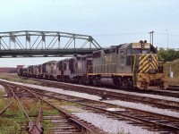 A rail strike in the US in 1978 I believe is the reason for this massive train's presense at Fort Erie. It had run over the CASO from Detroit. D&H 7412 (x-RDG), N&W 830, 2493, D&H 7420, N&W 2709, xxxx and 1572 was the power up front. (Approval for 6 axle units along the line not given until November of 1998) Train is stopped under the Central Av bridge, awaiting clearance to enter the USA via the International Bridge.