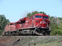 CP ES44AC 8704 leads an eclectic mix of motive power in the form of GP9u 1604 and SD40-2F 9019 eastbound out of Chalk River, Ontario on May 1st, 2006 with Train 108.

Having just passed Milepost 114 on the now abandoned CP Chalk River Subdivision, the head-end crew still hasn't clued into the fact they haven't turned the headlights back on after a meet in town with Train 107.