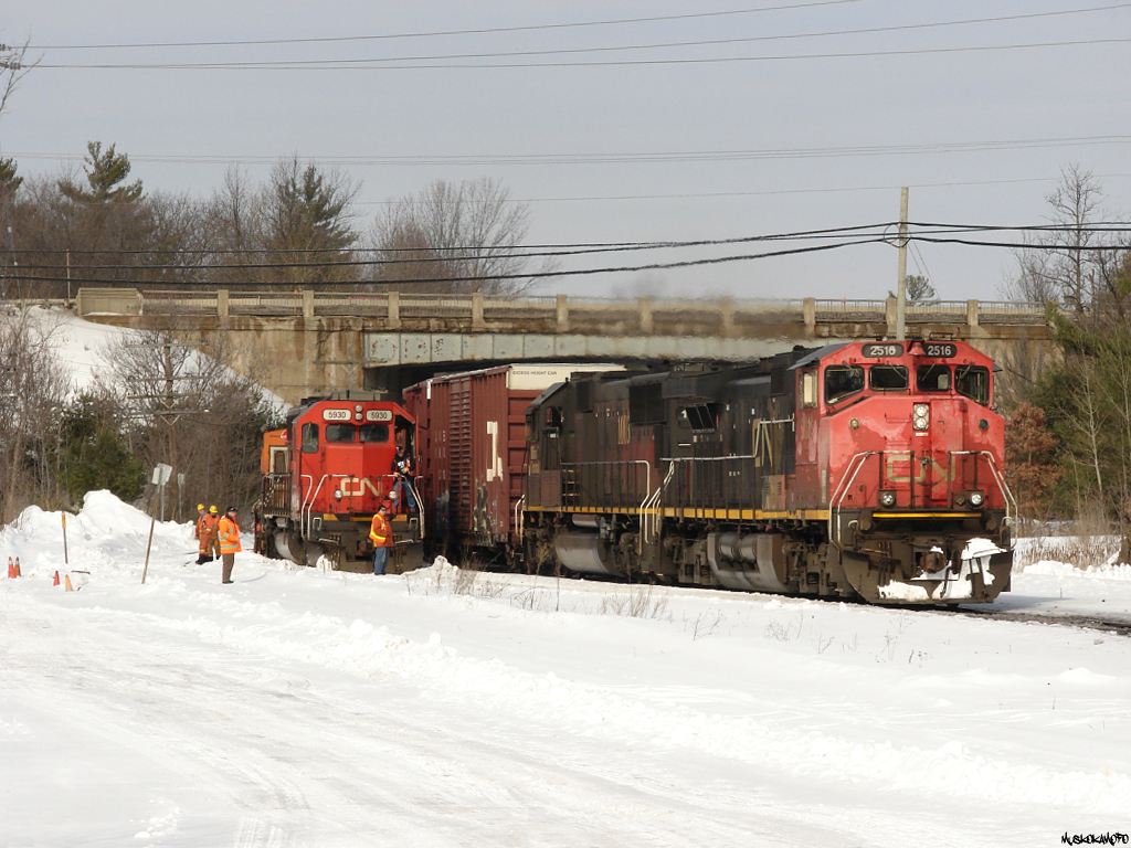 CN Q11451 21 - CN 2516 South overtakes CN W90831 26 sitting in the old Bala sub siding @ Washago.