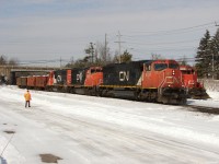 CN X31431 26 - CN 5737 South receives a PK inspection from the crew of W90831 26 seen tucked away beside them on the Newmarket sub waiting for L59531 26 to clear the block ahed in Gravenhurst before shoving Northwards to dump some rail on the Newmarket sub. Adding a little fun to their so far slow and boring day, the engineer and conductor of W908 started a snowball fight over the top of X314 with each other during the roll by!