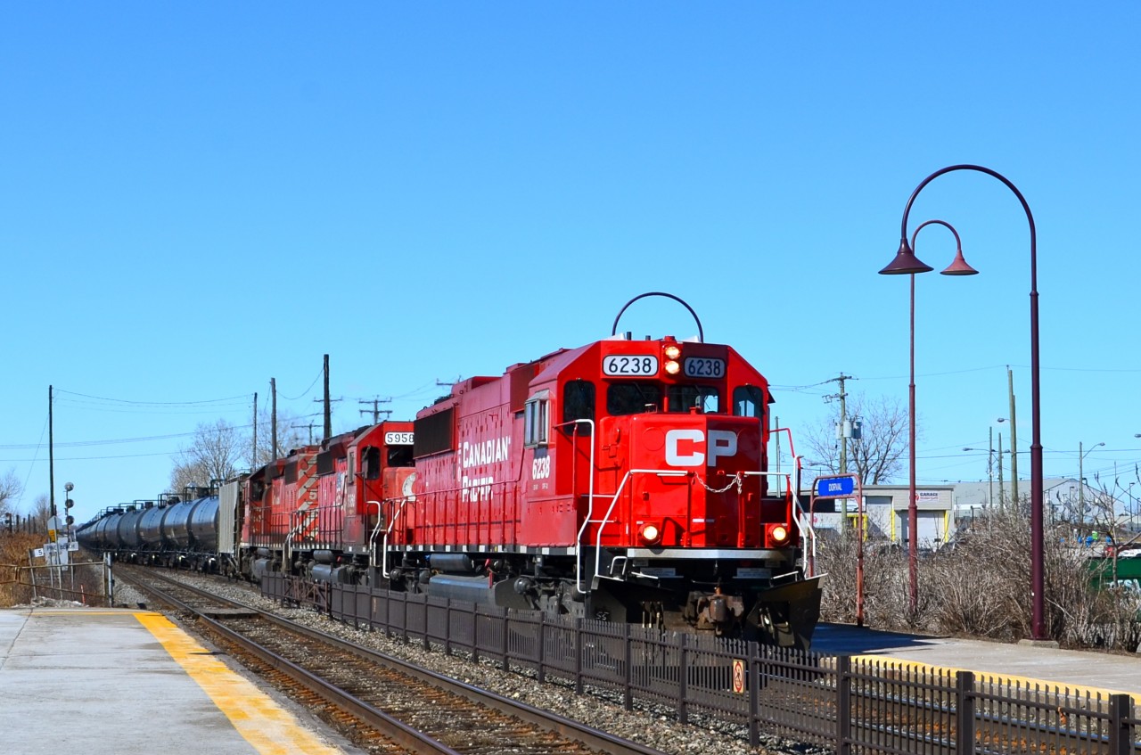 CP has been running an increasing number of unit oil trains recently. This morning I just missed an eastbound oil train led by two CP GE's and with a 9300 class GEVO as the rear end DPU, but in under an hour another eastbound oil train passed through Dorval with a sweet, all-EMD consist of CP 6238, CP 5958 & CP 58??.