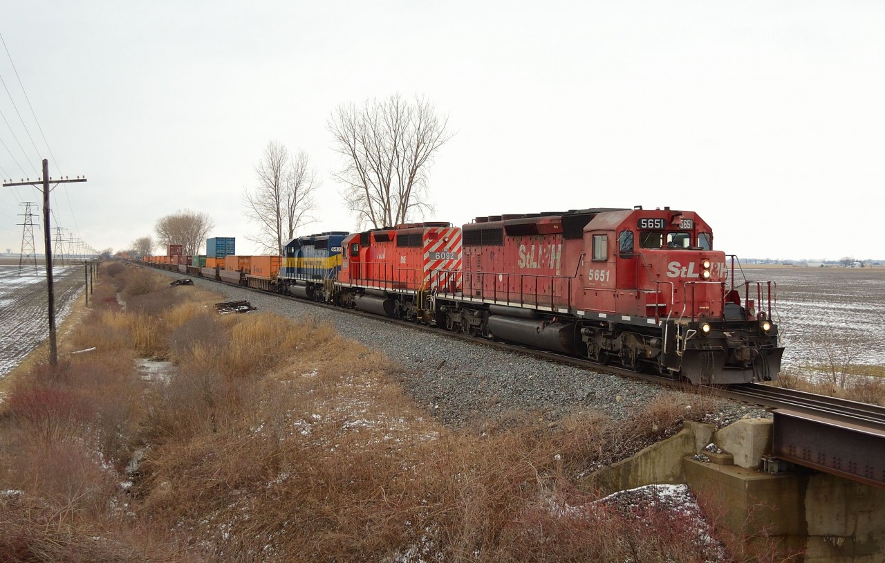 With a pleasing change from the usual GE power, CP 142 heads eastbound thru Jeannette mile led by St.L&H 5651, DME 6092 & ICE 6433 on a gloomy afternoon.