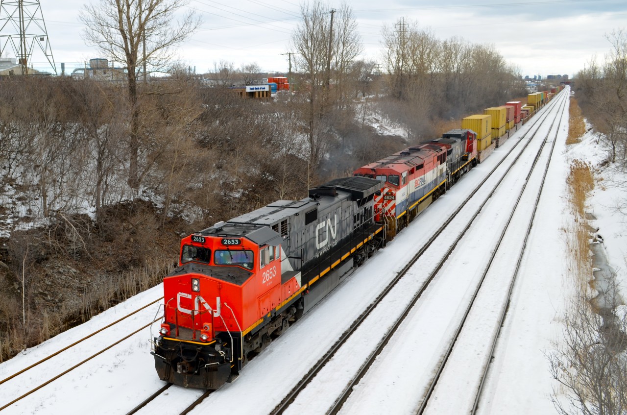 Same overpass and same leading engine... See the photo linked below to see a solo CN 2653 leading a short train underneath the Norman overpass in Lachine. This morning it was leading BCOL 4624 & CN 2153 and a long stack train. It would not enter Taschereau Yard but would continue west through Dorval and points west. http://www.railpictures.ca/?attachment_id=8935