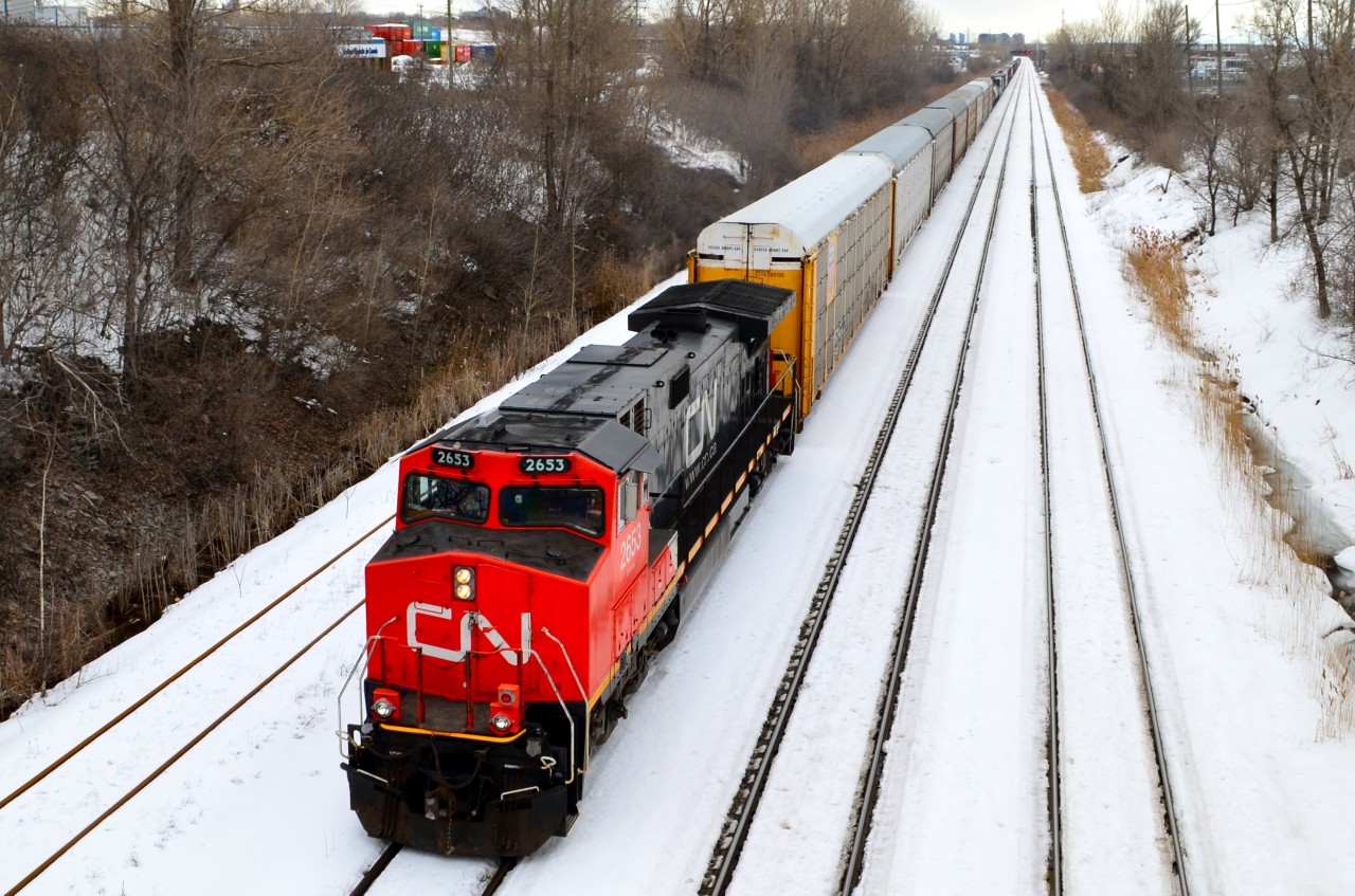 CN 2653 is in surprisingly good paint as it heads west through Lachine with a short train, on a gray afternoon. In a couple of minutes it will terminate at nearby Taschereau Yard.