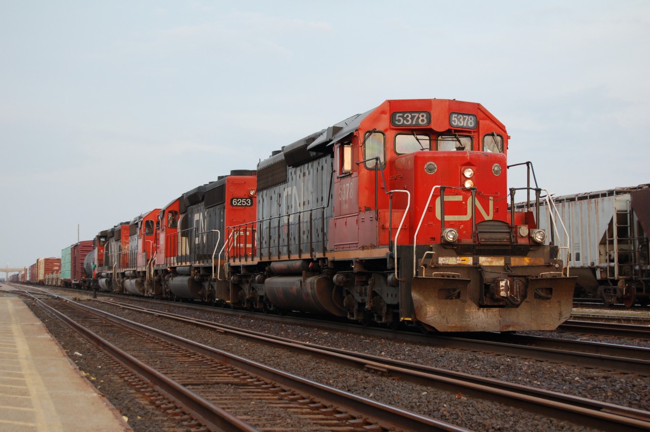 A 4 pack of CN SD40's rolls west past the station at Sarnia Ontario. By this date most of the older SD types were becoming harder to find let alone 4 different ones on a single train. Units included CN 5378, CN/IC 6253, CN 6017 and CN 5346.