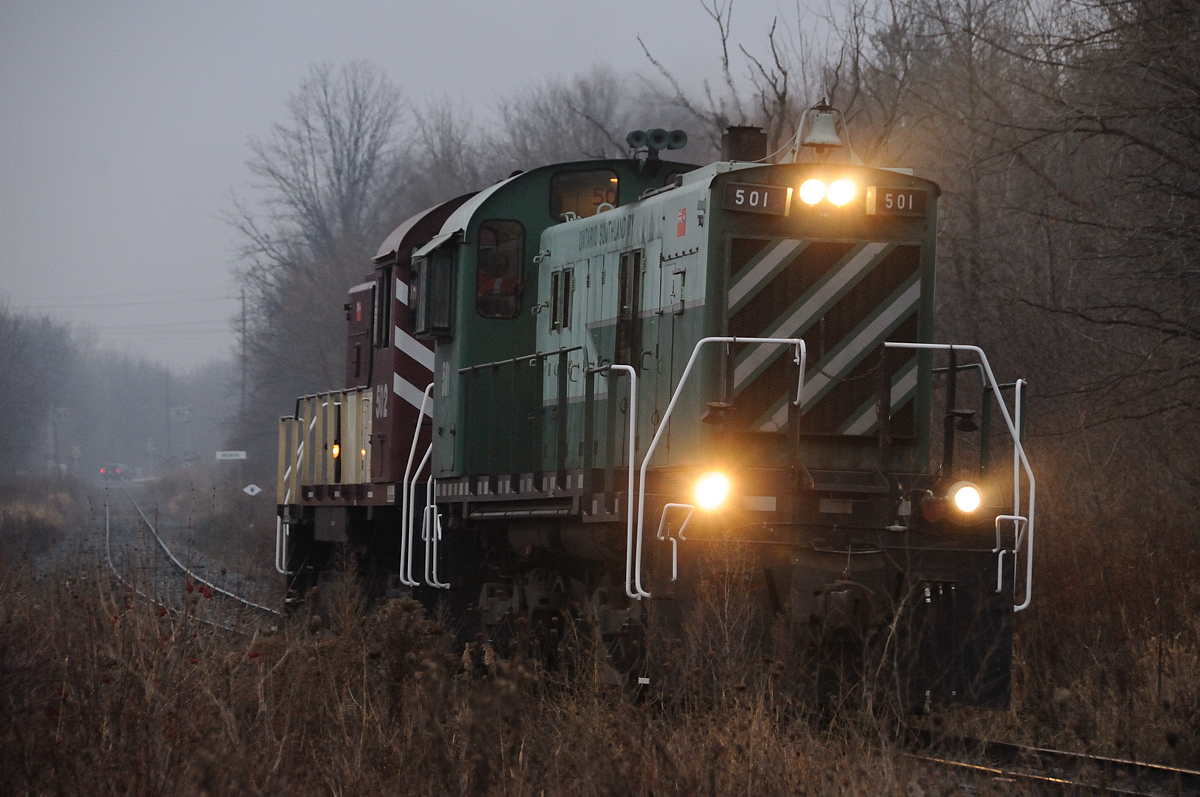 The bright lights of the Ontario Southland Railway will continue to guide the way for customers on this old CP branch as the next chapter of branchline railroading in southwestern Ontario continues on, during this dreary, dark December day. OSRX S13's 501 and 502 run light down the St. Thomas Sub to grab their first revenue freight from the Cami Auto Compound in Ingersoll, Ontario.