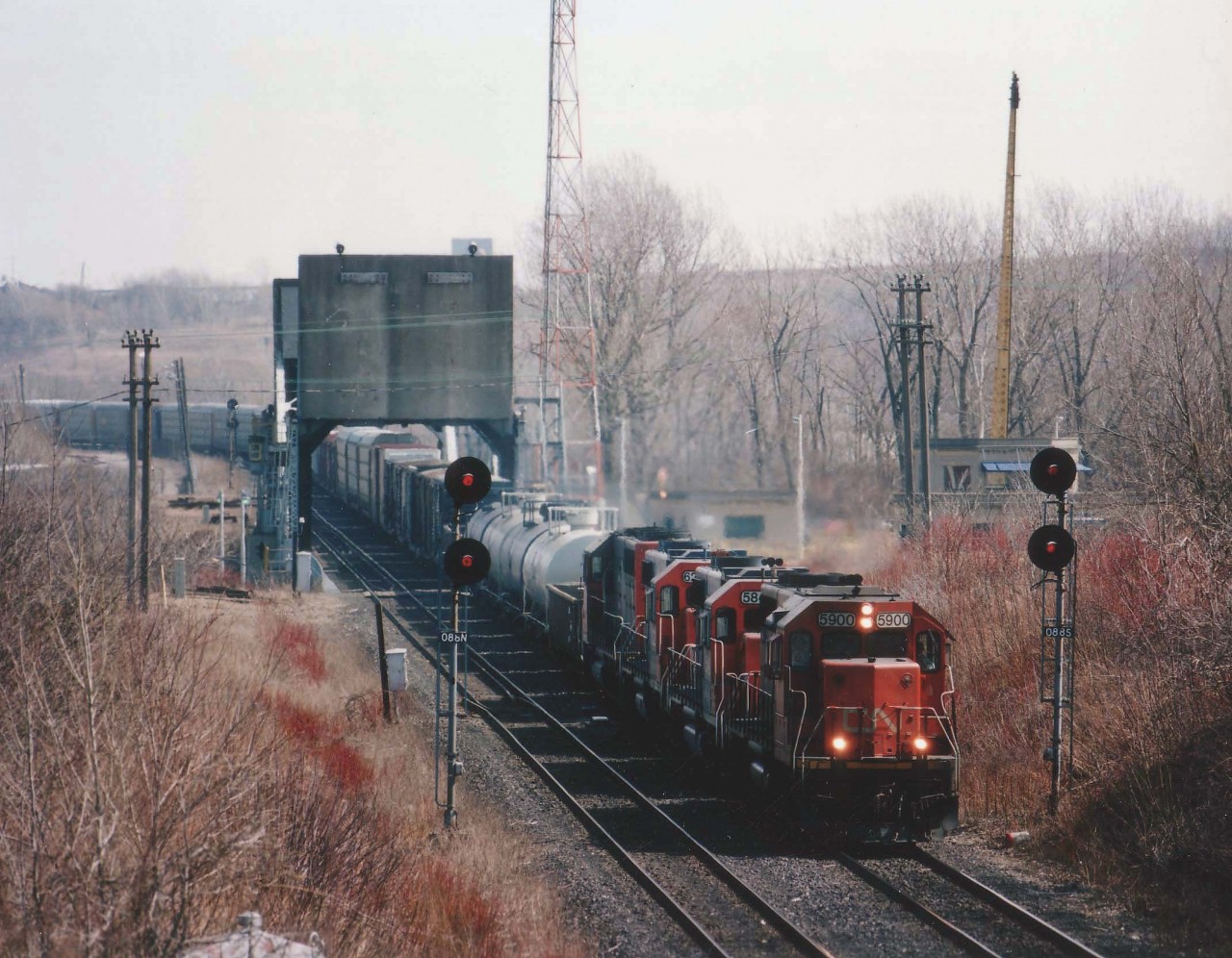 This image, although a bad sun angle, is noteable in the fact that this CN #332 is represented by no locomotives that are pure CN. Up front on this Toronto-bound train are GTW 5900, GT 5849, GT 6222 and GTW 5920, seen here crossing over the Welland Canal near Merritton in a late morning photo.
In 1997 the number 332 was assigned for a Buffalo-Toronto daily freight; its counterpart was #333.