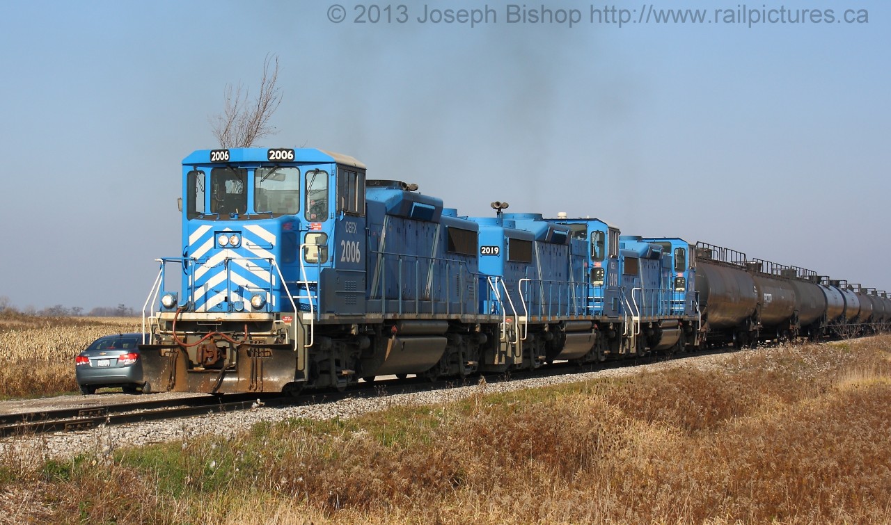 Smoke a Little Smoke Three GP20D's smoke it up as they are notched out with a long cut of tank cars in the Garnet Yard.