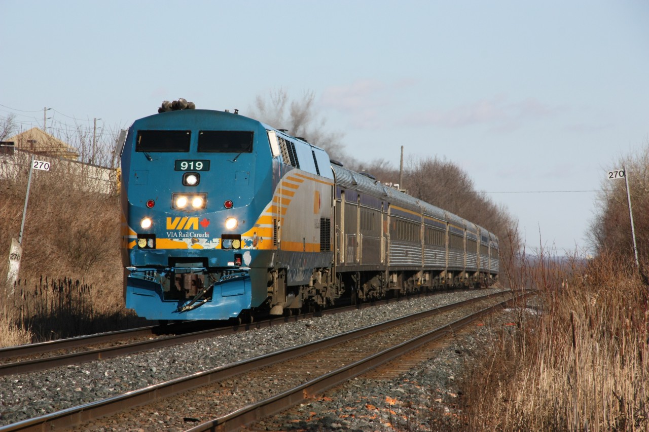 VIA P42DC 919, with some wear and tear evidence on the nose, reduces speed approaching the Hope Street level crossing in Port Hope, Ontario on February 20th, 2012. Note the old stone mile marker on the left, likely dating back to the days of the Grand Trunk Railway.