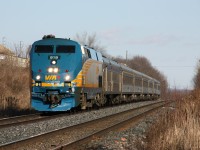 VIA P42DC 919, with some wear and tear evidence on the nose, reduces speed approaching the Hope Street level crossing in Port Hope, Ontario on February 20th, 2012. Note the old stone mile marker on the left, likely dating back to the days of the Grand Trunk Railway.