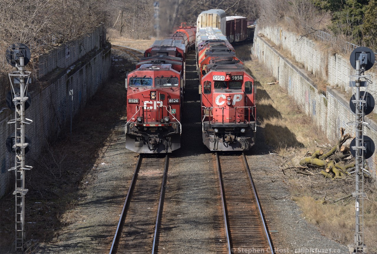 Numberboard misfits: CP trains 547 (Right) and Train 246 (left) both with mismatched numberboards sit side by side at Locke on the CP Hamilton Sub - the former Toronto Hamilton and Buffalo Railway. 547 sits waiting for a crew and 246 is about to pull clear of the west leg of the Waterford sub wye to back into aberdeen with a cut of coil cars.
Are the spartan numberboards a sign of Hunter Harrison's leaner CP?