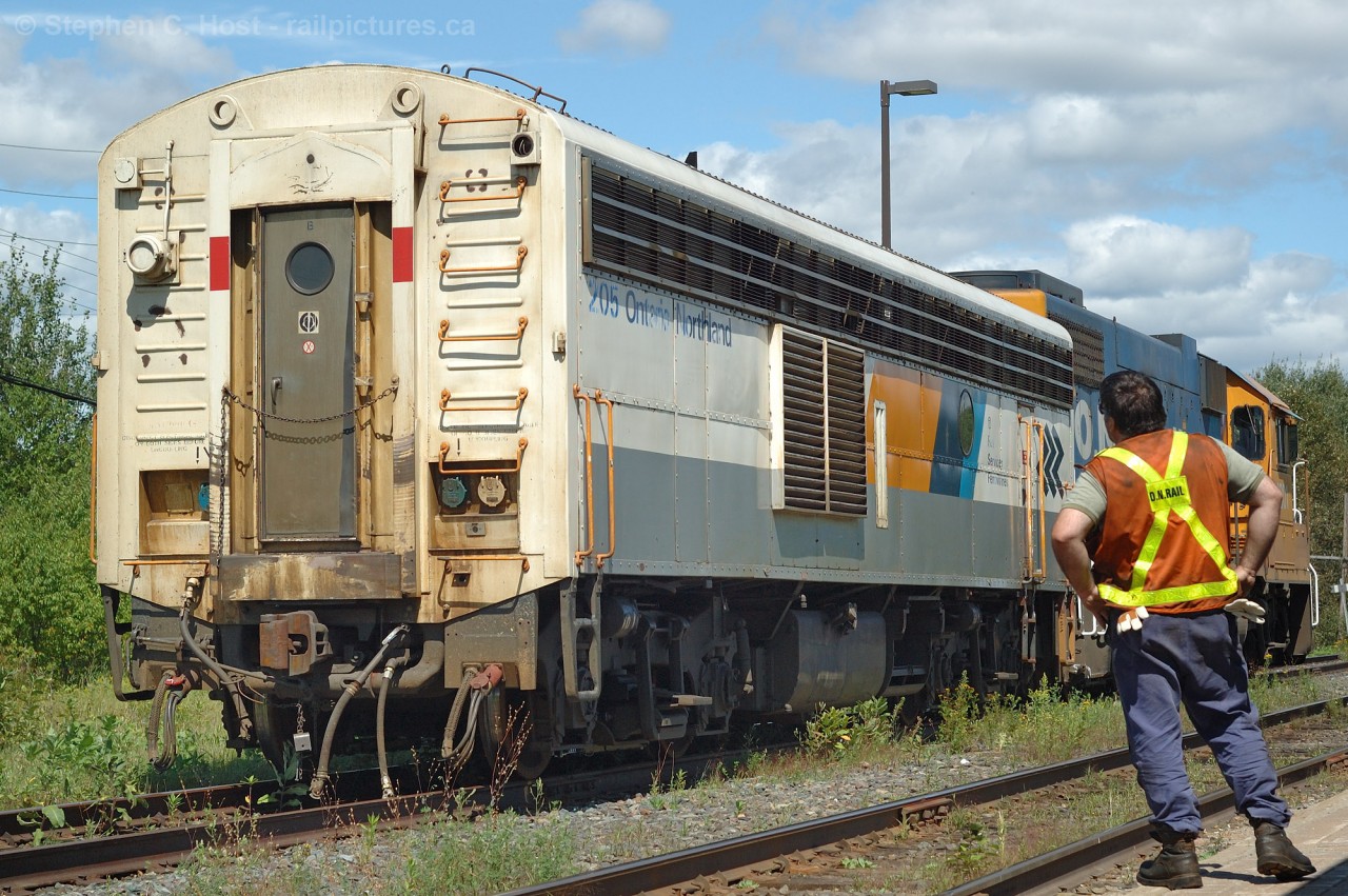A hostler from O.N. Rail (per Vest) looks over Train 697's rescue power as the move is about to begin..