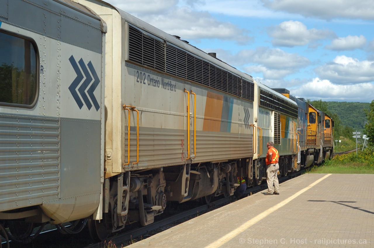 Hostlers: Here we see the hostlers, one underneath the APU's and one observing - connecting cables between the newly re-arranged power. The final power consist was 1808-1801-205-202. With a 30 minute delay under their belt the train departed for Cochrane and t©©he railway activity at the North Bay station was done for another day.