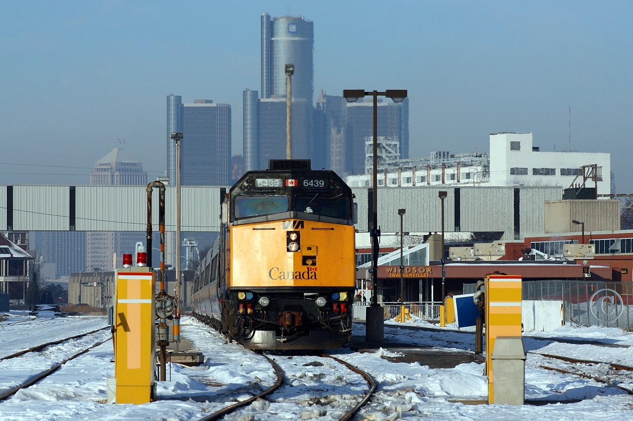 VIA 6439 readies for departure with Windsor (Walkerville) to Toronto train 72. Detroit's GM Renaissance Center looms in the background.