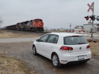 [editors note: Yes this picture has an edit on the license plate, we will allow this] CN 8921 & IC 1008 fly pass the town of Kerwood, with my vehicle, a 2013 VW Golf TDI. It was great to have this Diesel driving around as I did over 550km of driving on just over 1/2 a tank of Diesel, and enjoying the smells of Diesel being pumped out of the Engines as they rolled pass.