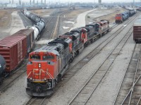 The Power from CN X348, backs to a Stub track, next to the Departure & Arrival yards in Sarnia. The train on the left is CN 330 getting ready to Depart, CN X348 power backing in with CN 8855 - CN 8805 - BCOL 4650 - BCOL 4604, the next track is the power getting ready for train X396 later in the day with CN 2551 - CN 5445 - CN 5484 with the carmen putting up the blue flag to get the train ready for departure. You can see on the right tracks full of cars, from trains that have just came in. In the distance you can see the CSX power sitting waiting to do work, CN locals on different tracks as well working. it was a busy time of day. 