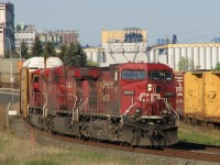 The stately grain elevators of JRI [James Richardson International] along the shore of Lake Superior on the 'Port Arthur' side of Thunder Bay provide the backdrop. A pair of AC4400CW's - cp9597 and cp9621 along with SD90MAC 9153 lead hotshot train CP#103. No remotes or distributed power back then! For the next mile the tracks are hemmed in by Fort William road on one side and CN's Thunder Bay North yard on the other.