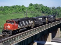 CN was power short in 1996/1997, and leased a number of units from Conrail, Wisconsin Central (SD45s), and Norfolk Southern C30-7s to name a few. The NS C30-7s were on their last legs, so I'm sure NS was more than happy to make a few bucks off them before they were retired. CN 143, with a pair of NS C30-7s trailing, is just starting in to the climb up Dundas Hill as they cross Hwy. 403. 