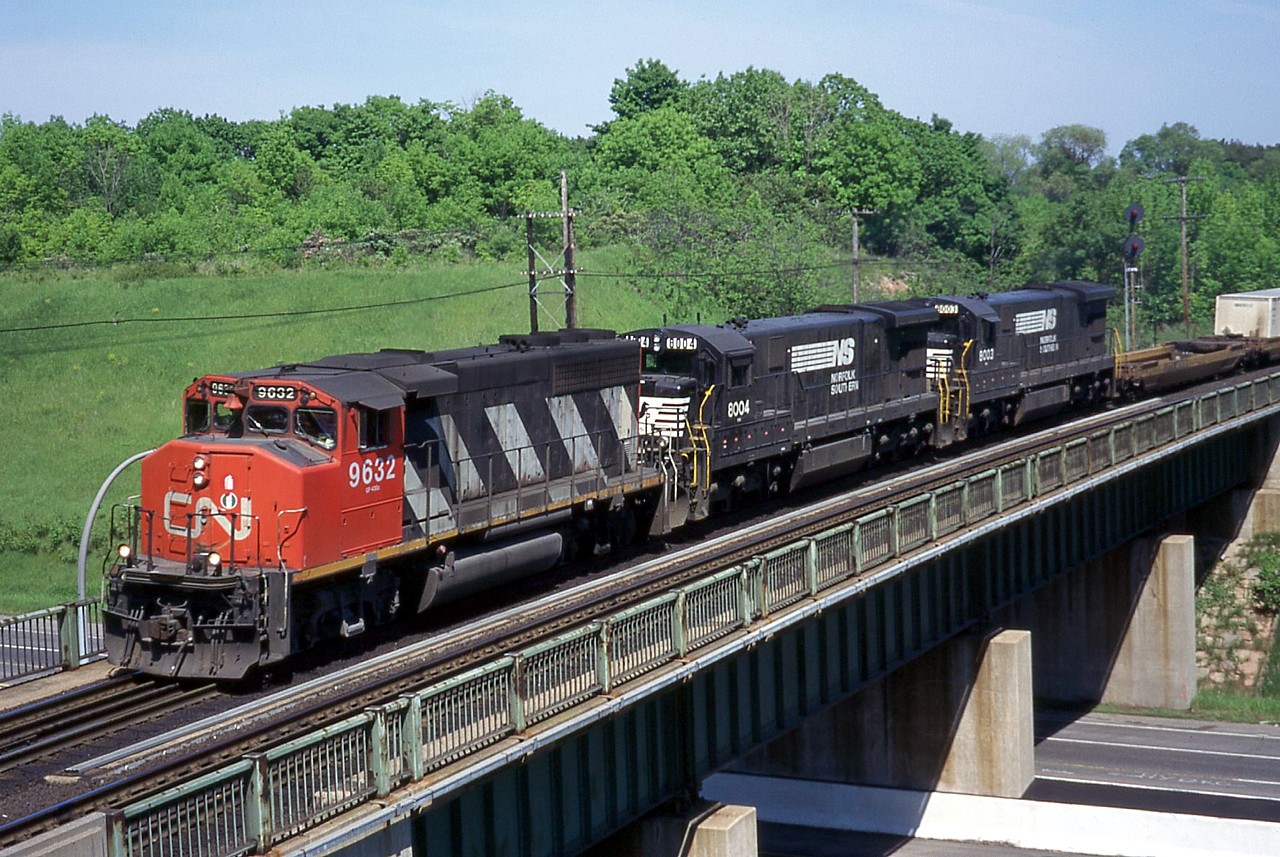 CN was power short in 1996/1997, and leased a number of units from Conrail, Wisconsin Central (SD45s), and Norfolk Southern C30-7s to name a few. The NS C30-7s were on their last legs, so I'm sure NS was more than happy to make a few bucks off them before they were retired. CN 143, with a pair of NS C30-7s trailing, is just starting in to the climb up Dundas Hill as they cross Hwy. 403.