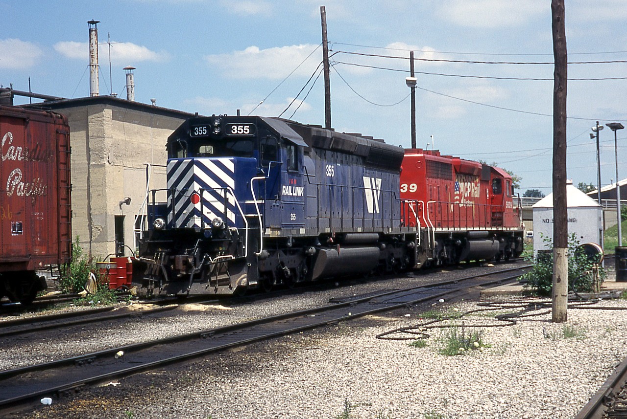 IMRL 355 and CP 5639 rest in London Yard. This was during the brief period that CP and IMRL were jointly running one train each way between Kansas City and Toronto.