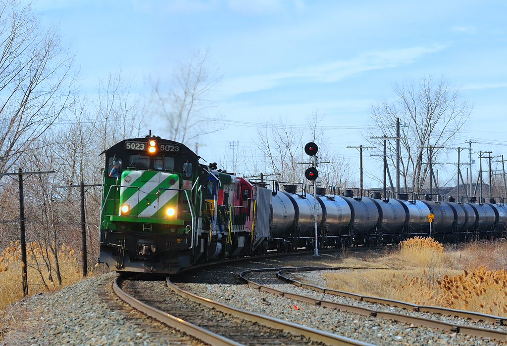 Bound for Farnham, a Montreal Maine & Atlantic crude oil train has just pounded the CP/CN diamond as it exercises trackage rights over Canadian Pacific.