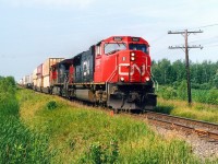 CN 120 with a very long string of containers.