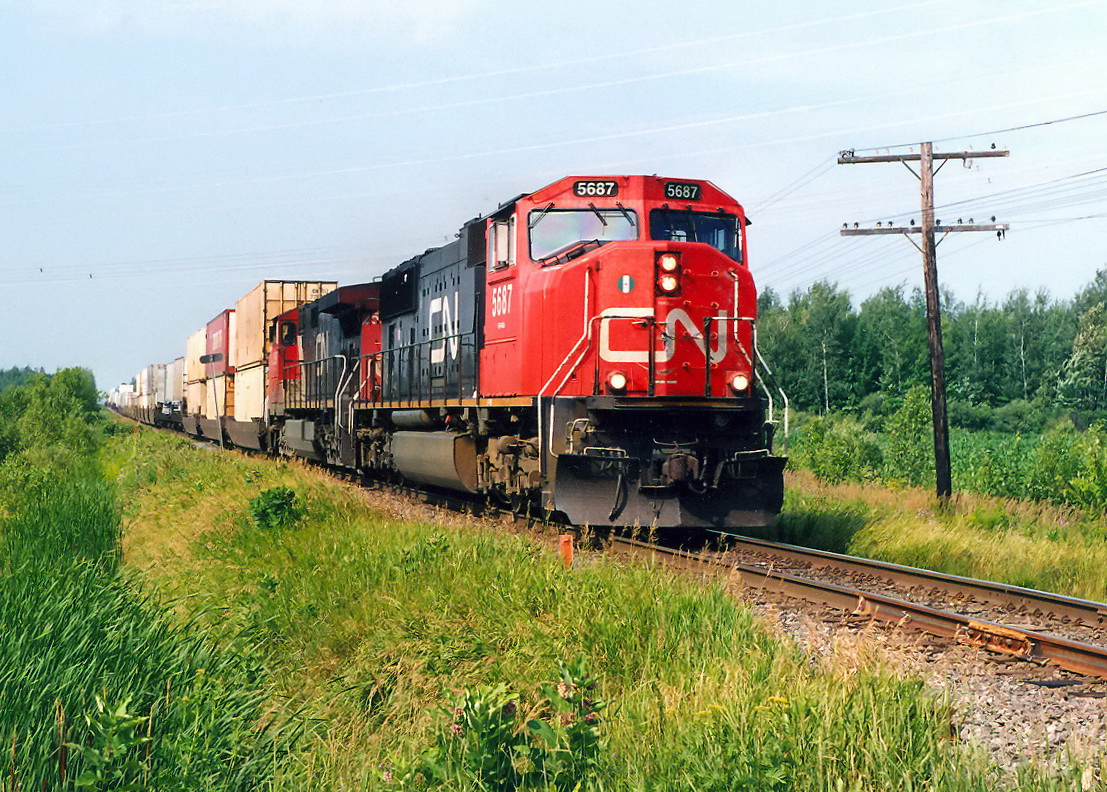 CN 120 with a very long string of containers.