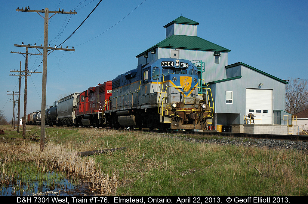 D&H GP38-2 #7304 leads sister #7307 on train T-76 on it's trip to Chatham as it rolls past the mill, now an office building, in Elmstead, Ontario.  Jay Butler nailed the shot of this train further east of Tilbury.
