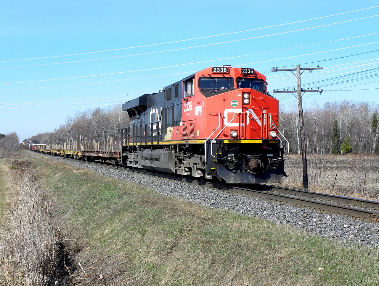 CN 310 with 8925 in mid train at speed through Aston east.