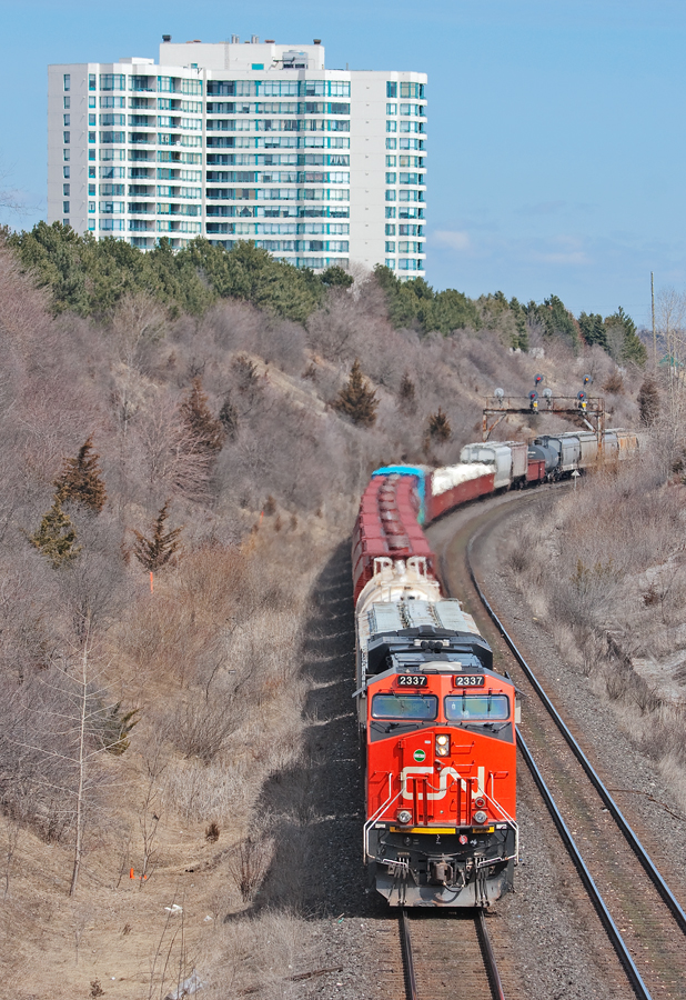 Moncton to Toronto daily manifest traffic, CN Train 305 is on it's final run to Mac Yard with 2337 leading and 8863 mid train and 11,000+ tons.