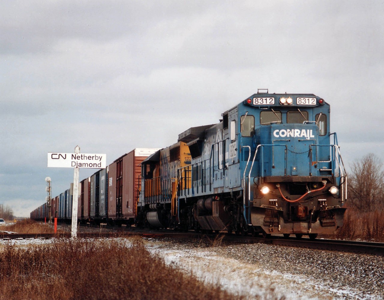 It sure was a tragic loss of locomotive paint scheme variety in Niagara with the demise of NS 327/328 in the late 2000s. Evident by this lashup almost anything could be seen. Heading Stateside is NS 8312, formerly Conrail 6047, with Ontario Northland 1733 the trailing unit. NS 'white patched' the unit numbers under the cab until there was an appointment at the black paint shop.