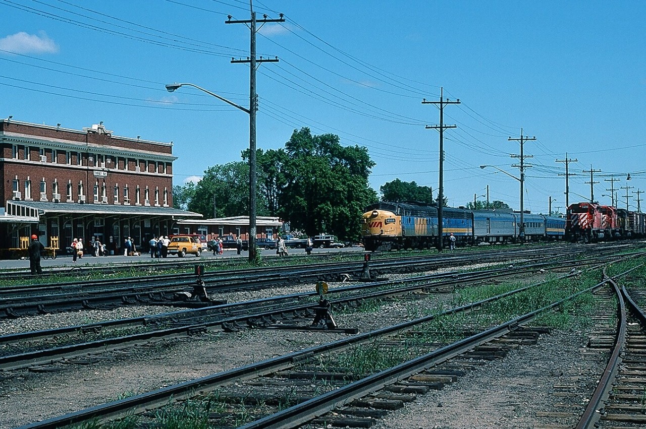 High Noon at Thunder Bay. 
Operating a little late  VIA  6505 – 66xx  pulls VIA Rail # 1 into the depot. CP carmen and maintenance workers await the arrival along with fourteen paying passengers on the (extra wide) track # 1 platform plus at least that many more are to exit the waiting room – wonder what form of transport all those people would use today?  
At the right is CP Rail #407 with 5593 leading including a foreigner - a QNSL ? -  waiting to follow # 1.
June 19, 1985 Kodachrome by S.Danko.

More VIA Northern Ontario:


  centre of the community   


  spectacular river bridge  


  Pacific Avenue overpass