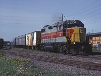 GP38-2 203 leads Sault Ste. Marie - Hearst train #1 through the urban area of the Soo before striking out into the northern Ontario wilderness. A leased Ontario Northland steam generator is providing steam for today's train. 