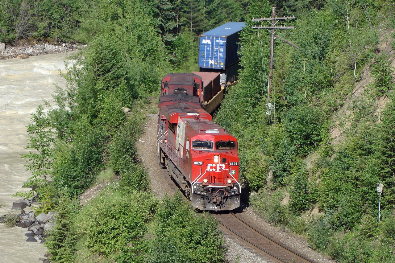 ES44AC CP 8876 in Vancouver Olympics livery and AC4400CW CP 9736 lead an eastbound train through the mountains east of Golden.
