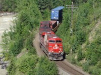 ES44AC CP 8876 in Vancouver Olympics livery and AC4400CW CP 9736 lead an eastbound train through the mountains east of Golden.