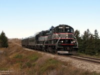 Cruising southbound from Orangeville with three loaded passenger cars and a pair of General Motors GP9's, the Credit Valley Explorer's "Fairwell to 1000" special rare-mileage run heads south through Alton, Ontario in the fall morning light. The up and down track profile here reflects the surrounding rolling hills of the Osprey Valley Golf Course quite well, but we're not here to play a game of golf today.