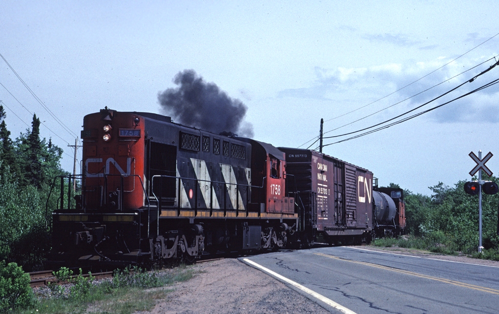 CN 1758 leads a train across St. Margarets Bay Road with a two car train along Nova Scotia's south shore.