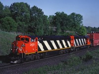 CN Dash8-40W 2420 leads an eastbound between Mansewood and Speyside (Mile 30 on the Halton Sub)