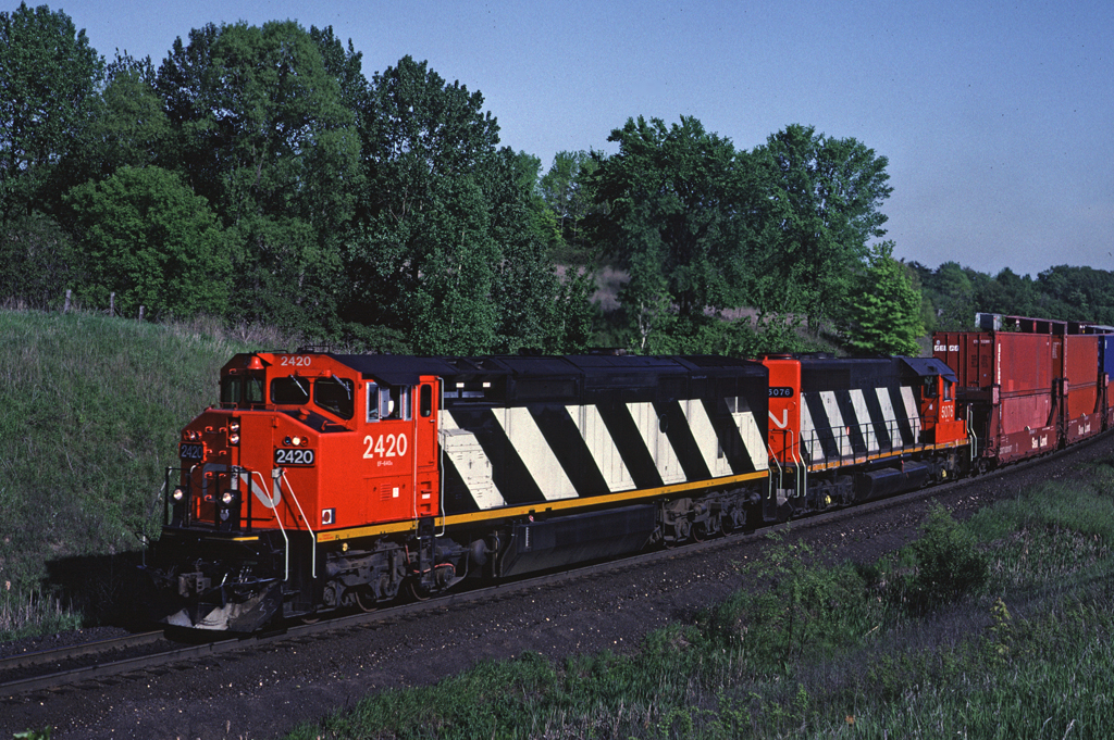 CN Dash8-40W 2420 leads an eastbound between Mansewood and Speyside (Mile 30 on the Halton Sub)