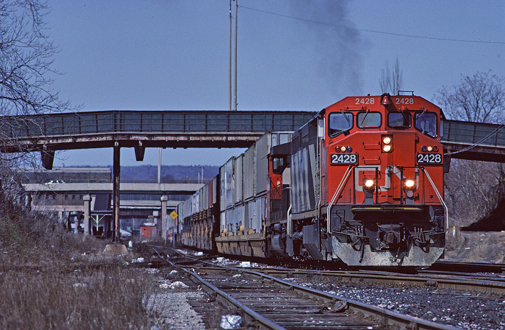 CN Dash8-40W 2428 leads Toronto - Buffalo doublestack  train #255 past Hamilton station.