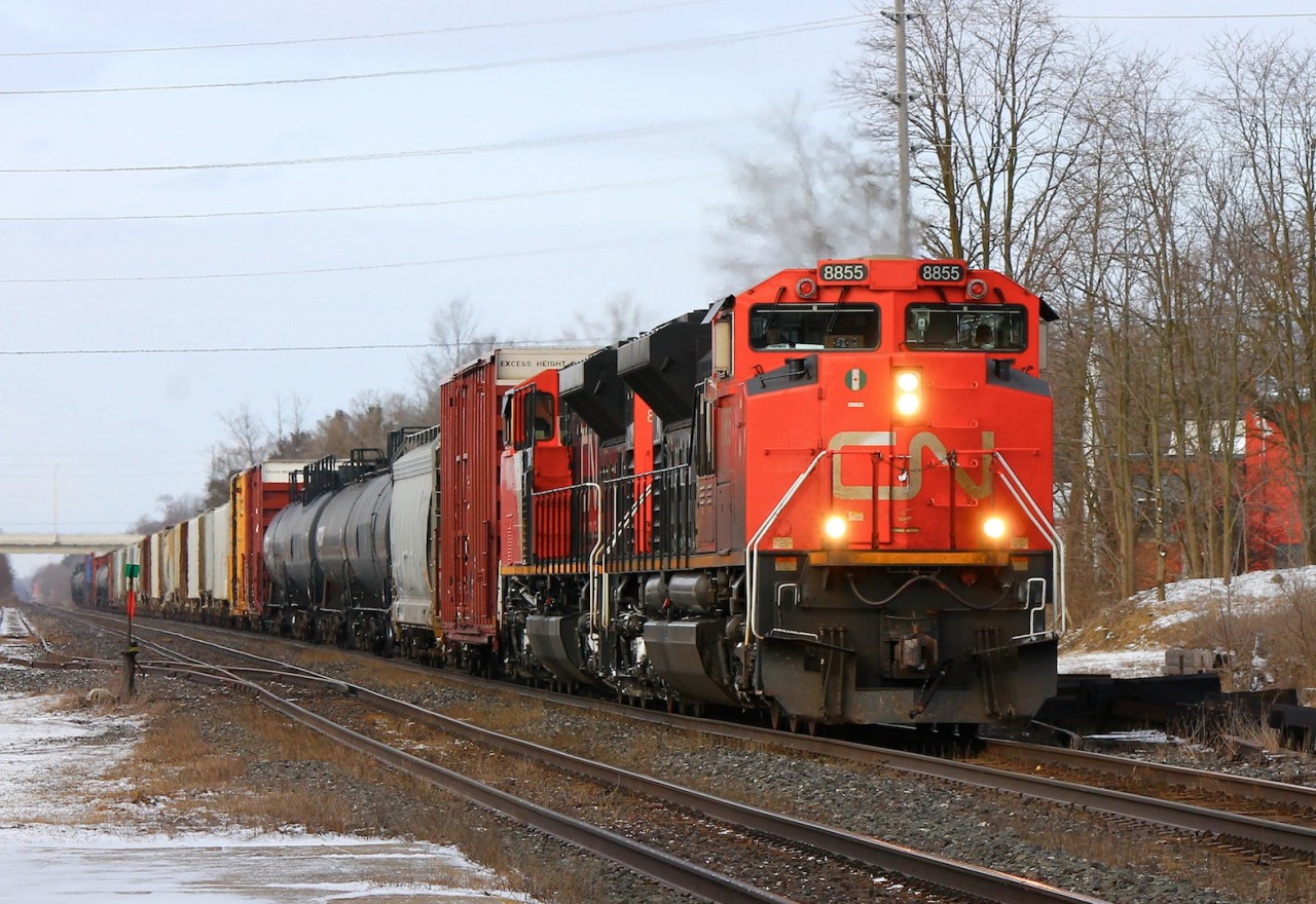 CN 332 blasts its horn as it rolls through Ingersoll Ontario with two EMD beasts in the lead.