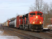 CN 332 blasts its horn as it rolls through Ingersoll Ontario with two EMD beasts in the lead.