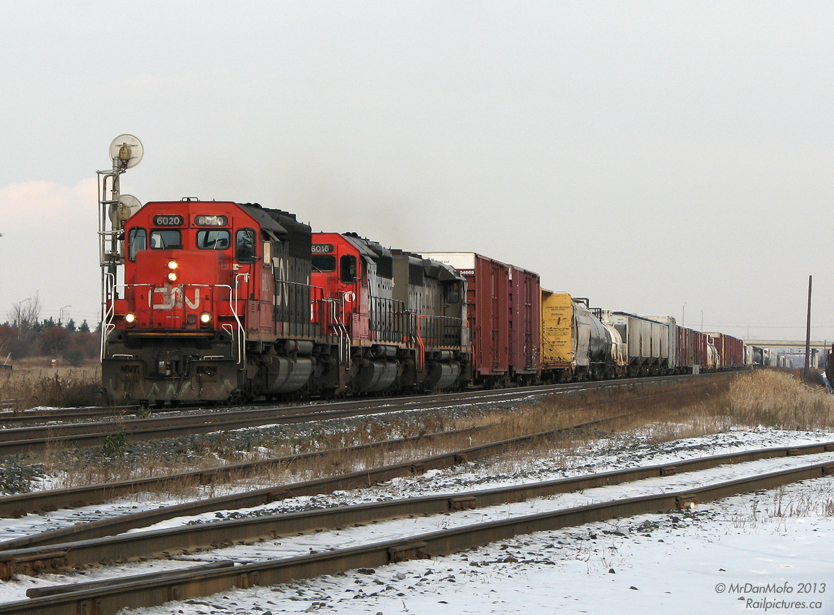 Roaring westbound through the city limits of Brampton and Mississauga, three rebuilt CN SD40's haul a long 399 upgrade between Torbram and Goreway, past Torbram Yard off to the right. Leaders CN 6020 & 6016 were remanufactured by CN as upgraded SD40u units, trailing unit WC 6944 was rebuilt as an Alsthom leaser, before it was then leased back to CN and sublettered WC. Today the 6000's are relegated to road and yard duties across the CN system, and the former WC/GCFX units have been sold off and spread across North America.