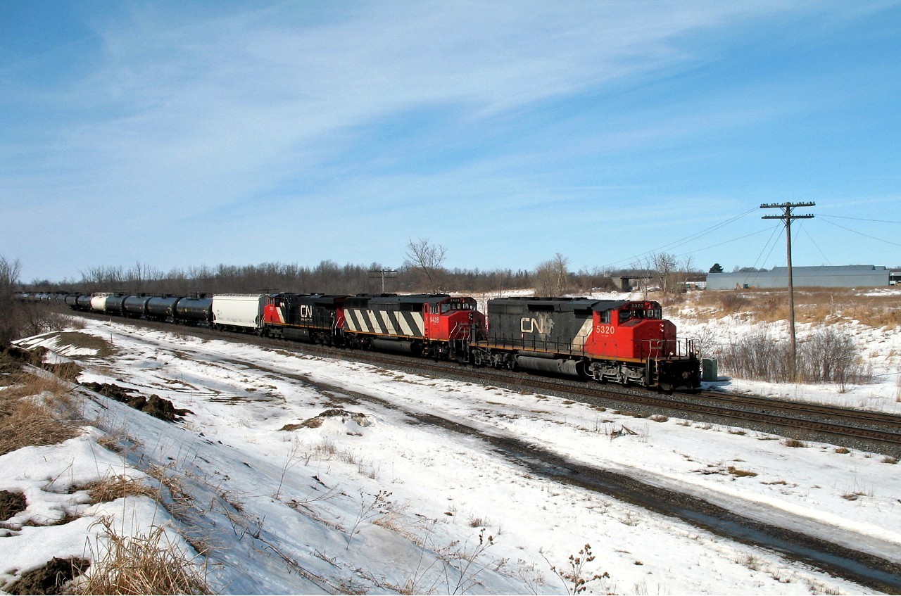 Annexed by the city of London in 1993, Hyde Park once featured a small station at this location, and a branch (Ilderton sub) that ran north from this location to Clinton Jct, on what is now the GEXR. Visible above the cab of CN 5320 is a bridge that allowed passage of trains northward under the CP Windsor Sub up until the early 1990's when the portion south of Exeter was abandoned and torn up. The crew of CN 330 probably doesn't notice the old right of way (now a hiking trail) as they coast downgrade towards London with a short train of mostly tank cars.