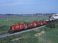 A quartet of SW1200RS leads a loaded gypsum train towards Hantsport on the Dominion Atlantic.