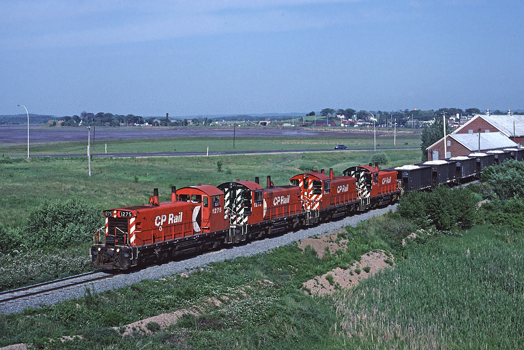 A quartet of SW1200RS leads a loaded gypsum train towards Hantsport on the Dominion Atlantic.